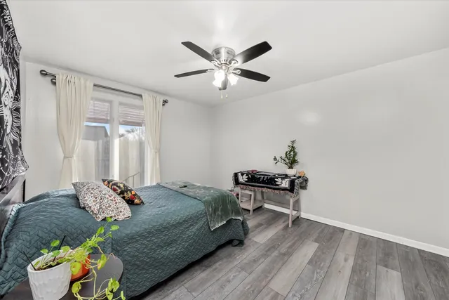 a bedroom with a bed and ceiling fan