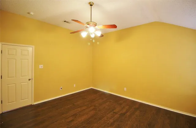 a view of a big room with wooden floor and a ceiling fan