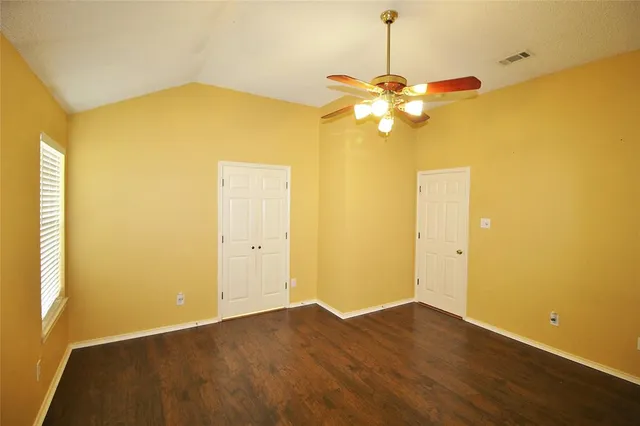 a view of a room with a chandelier fan and a large window