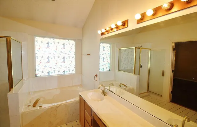 a bathroom with a tub sink and a mirror