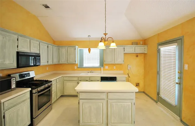 a kitchen that has a sink and a stove