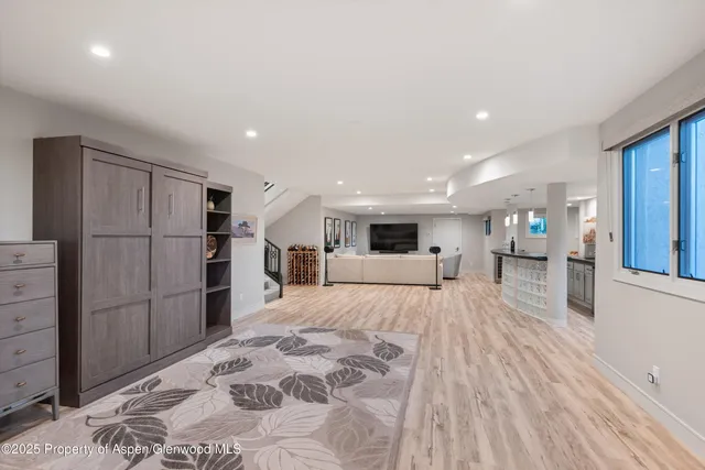 a large bedroom with a bed and a flat screen tv