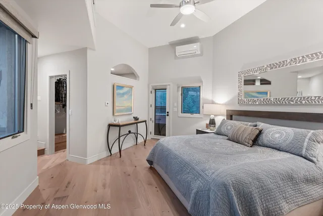 a bedroom with a large bed and a chandelier