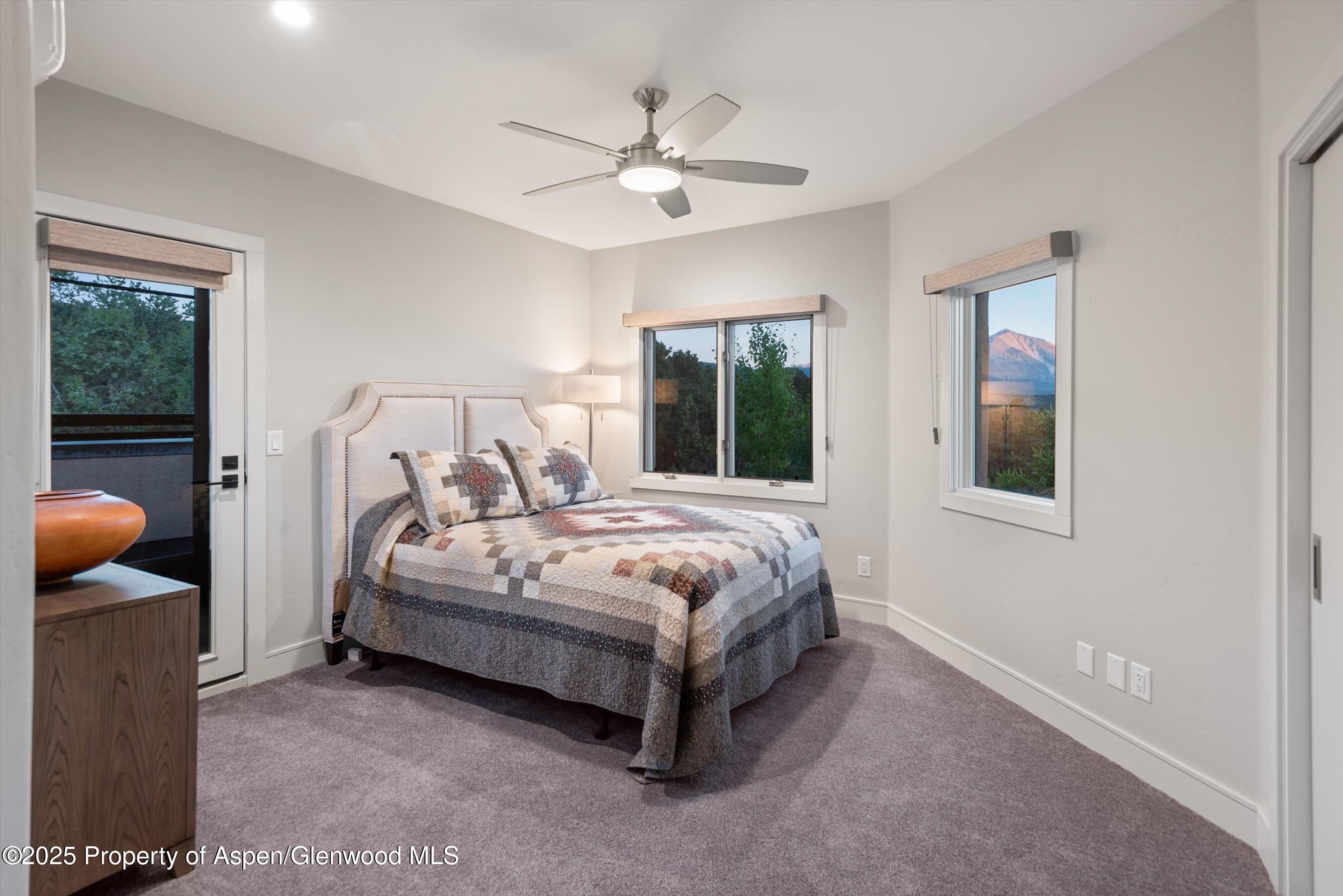 384 Wooden Deer Road Carbondale, CO 81623 - Photo 27 of 48 a spacious bedroom with a bed and window