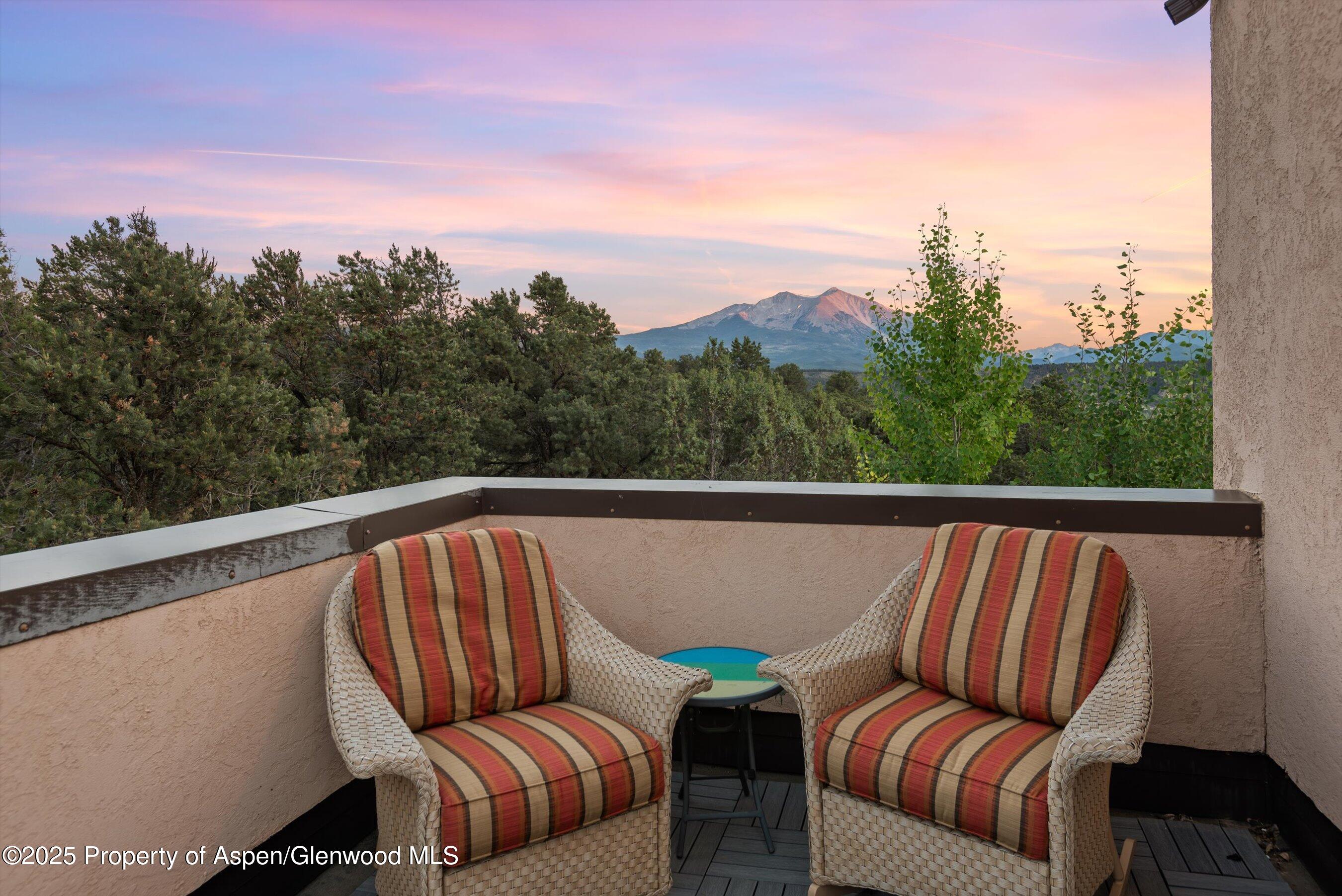 384 Wooden Deer Road Carbondale, CO 81623 - Photo 28 of 48 a balcony with outdoor seating and green space