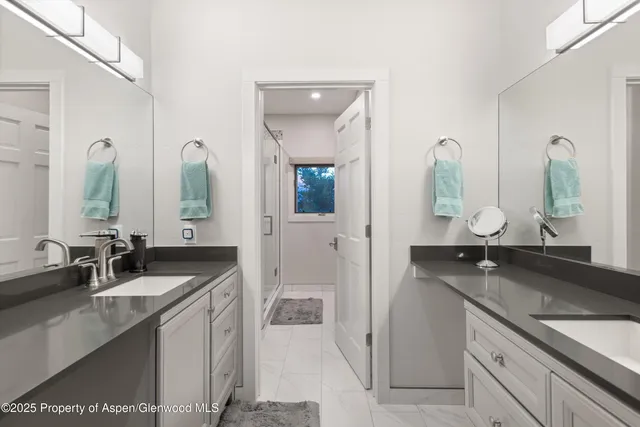 a en suite bathroom with double sink and a mirror