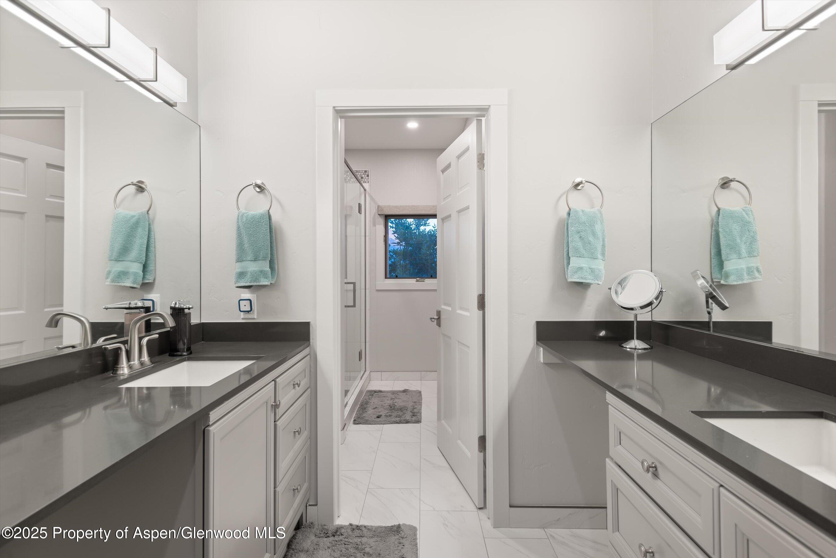 384 Wooden Deer Road Carbondale, CO 81623 - Photo 30 of 48 a en suite bathroom with double sink and a mirror