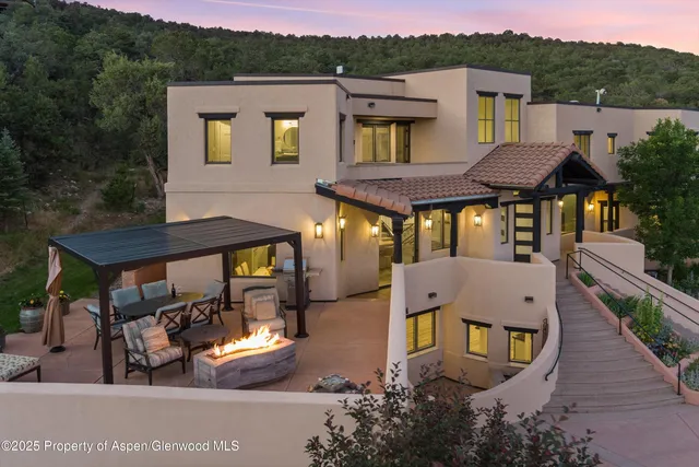 a front view of a house with yard and furniture