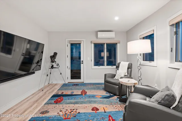 a bedroom with furniture and a flat screen tv