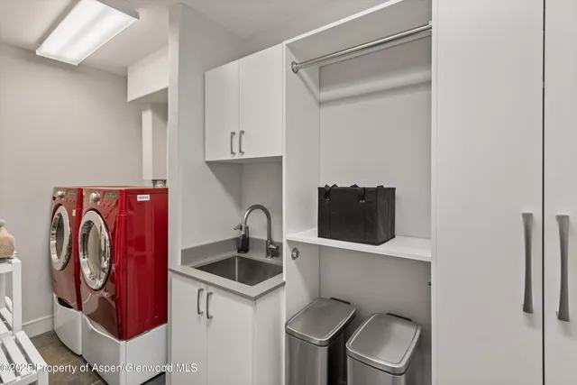 a kitchen with stainless steel appliances granite countertop a sink and a refrigerator