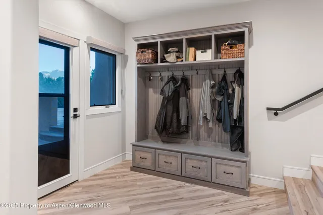 a view of an entryway with wooden floor