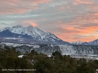 a view of a dry yard with mountains in the background