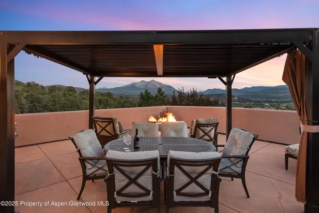 a view of city from a balcony with furniture