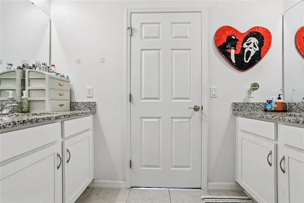 a bathroom with a granite countertop sink a vanity and a shower