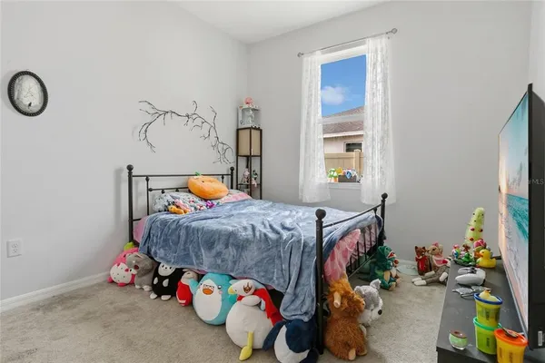 a bedroom with a bed and window