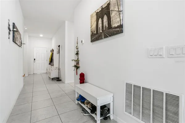 a hallway with a white stove top oven and cabinets