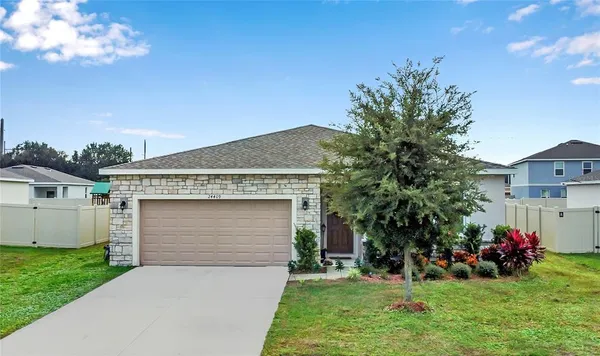 a front view of a house with a yard and garage
