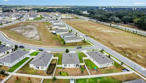 an aerial view of multiple houses with yard