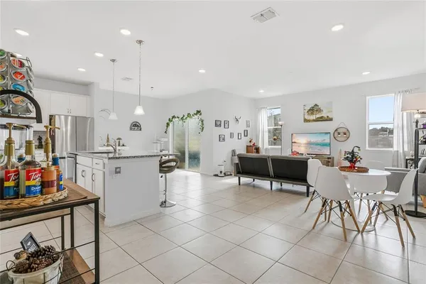 a living room with furniture a dining table and chairs