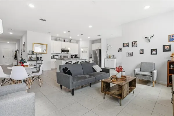 a living room with furniture and kitchen view