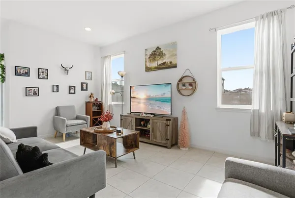 a living room with furniture a window and a clock