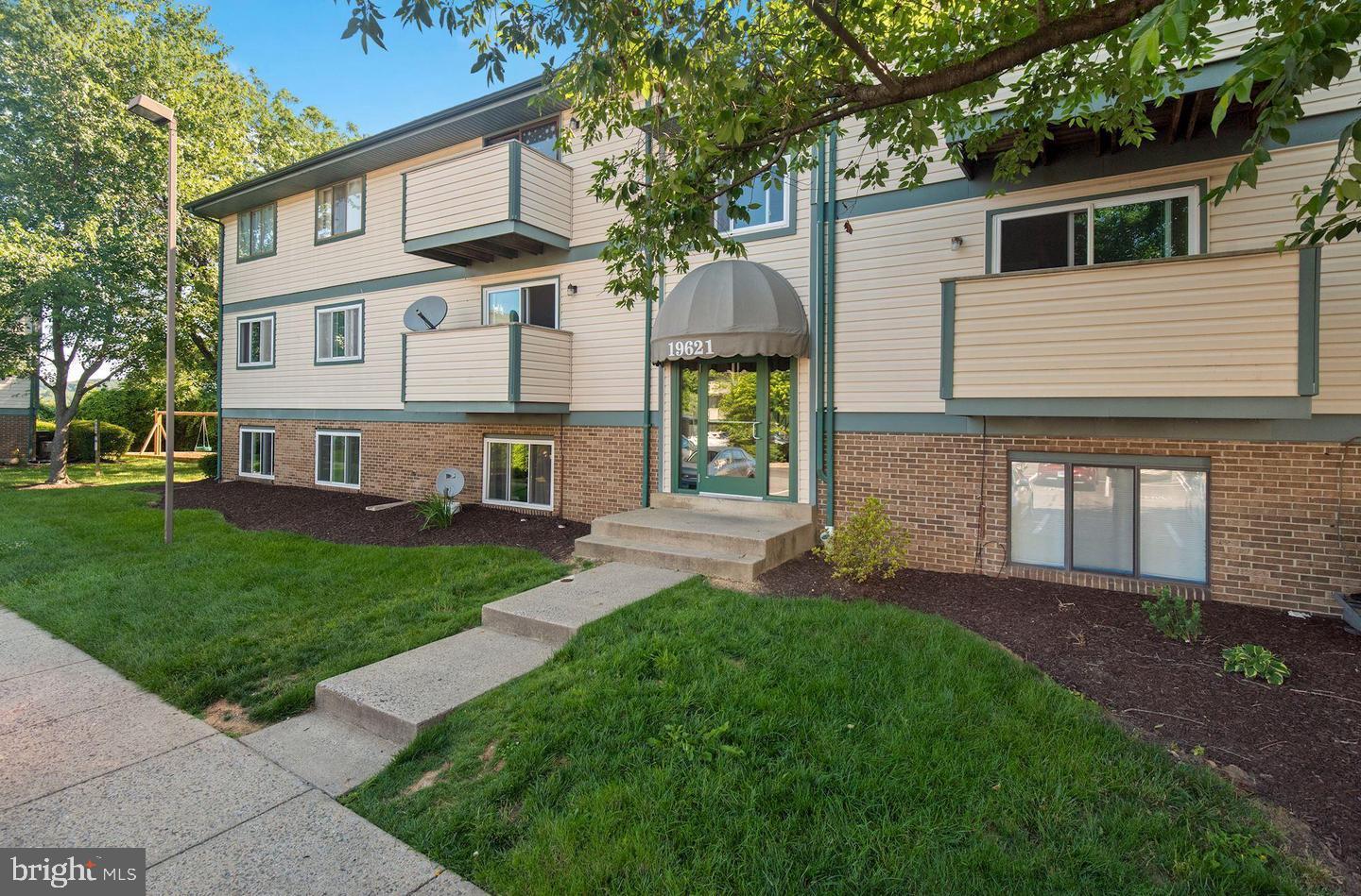 19621 Gunners Branch Road, Unit 823 Germantown, MD 20876 - Photo 1 of 49 a front view of a house with a garden and yard