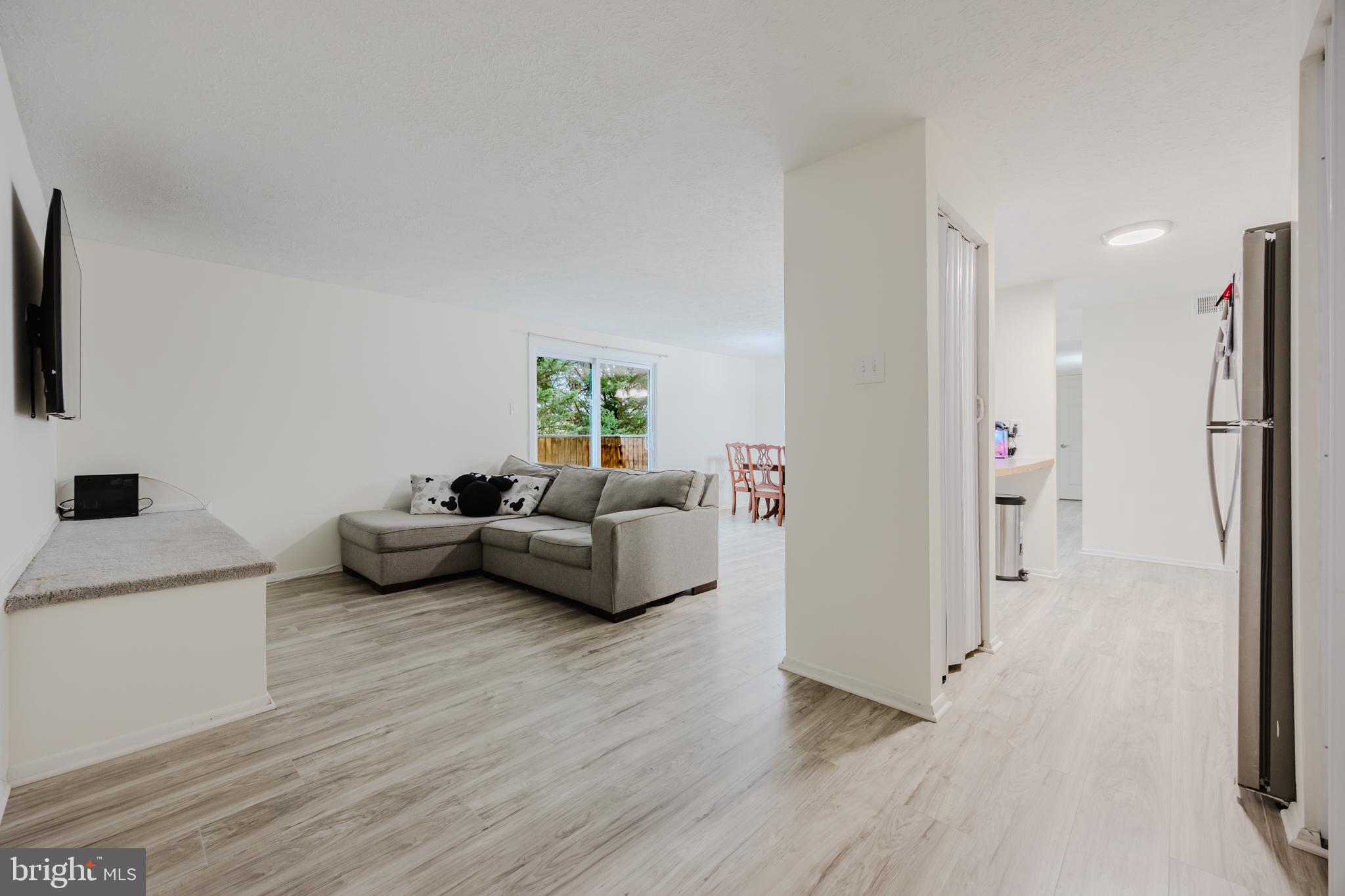 19621 Gunners Branch Road, Unit 823 Germantown, MD 20876 - Photo 14 of 49 a living room with furniture and a flat screen tv