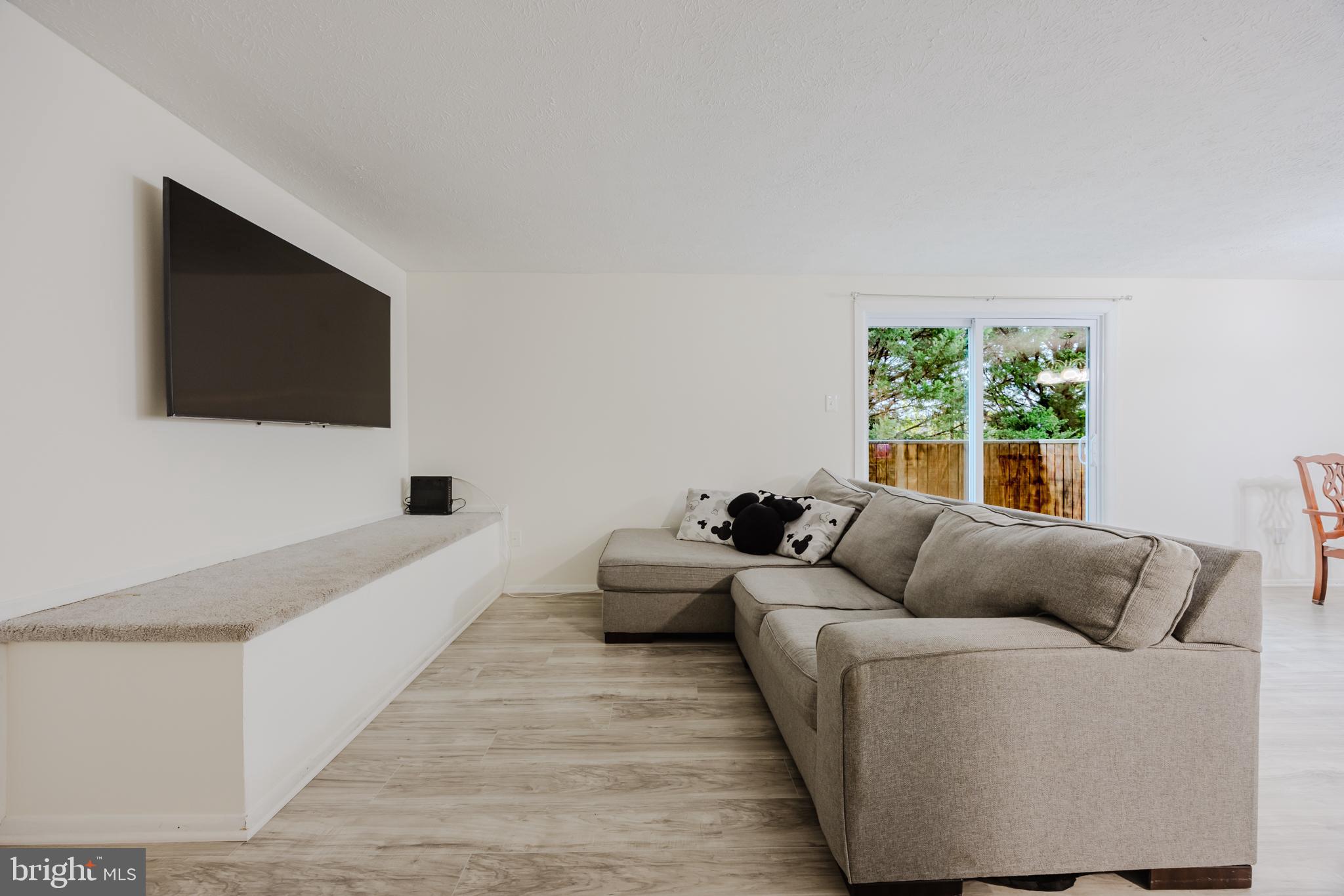 19621 Gunners Branch Road, Unit 823 Germantown, MD 20876 - Photo 15 of 49 a living room with furniture and a flat screen tv
