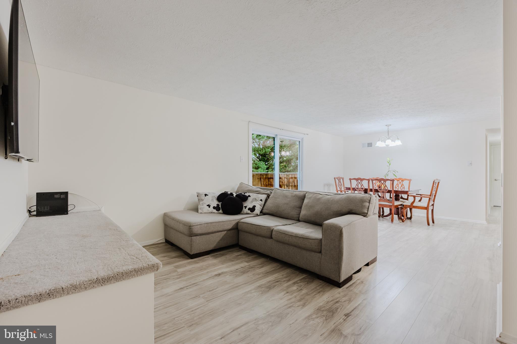 19621 Gunners Branch Road, Unit 823 Germantown, MD 20876 - Photo 16 of 49 a living room with furniture and a flat screen tv