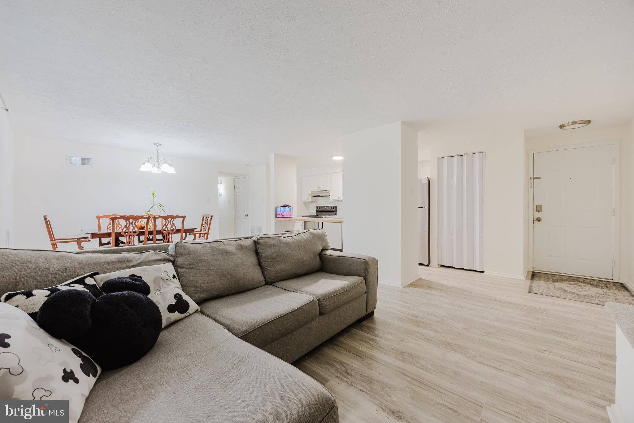 19621 Gunners Branch Road, Unit 823 Germantown, MD 20876 - Photo 17 of 49 a living room with furniture and a wooden floor