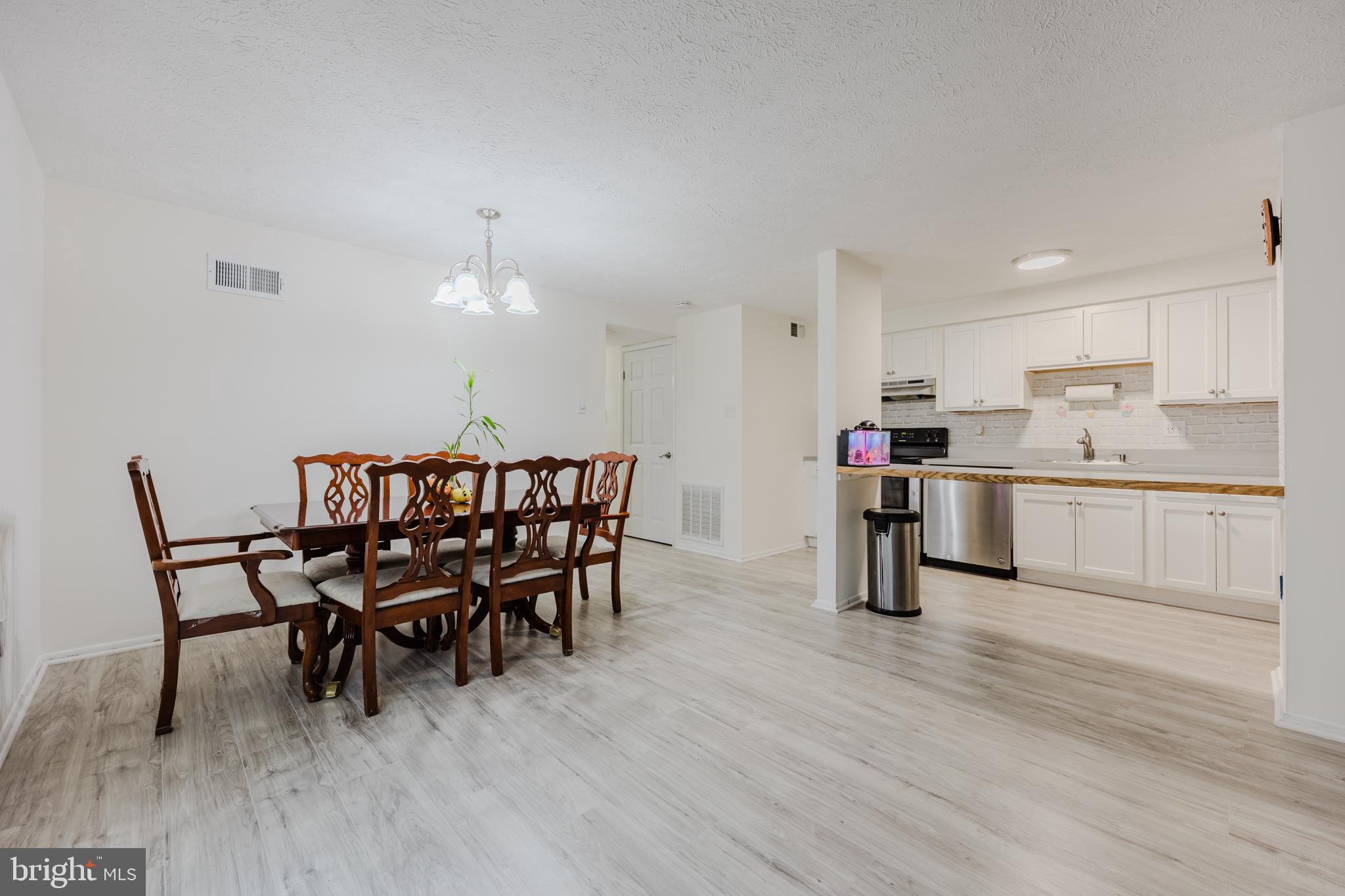 19621 Gunners Branch Road, Unit 823 Germantown, MD 20876 - Photo 18 of 49 a view of a dining room with furniture and wooden floor