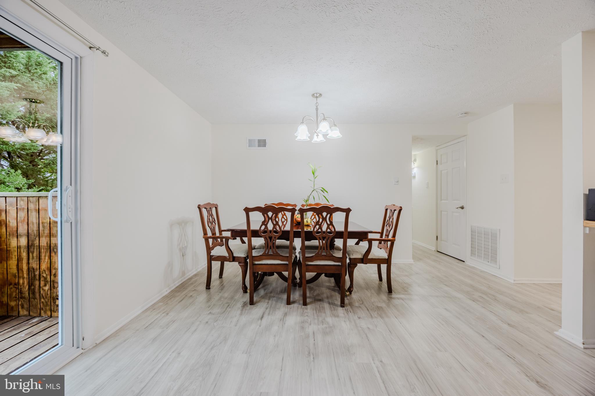 19621 Gunners Branch Road, Unit 823 Germantown, MD 20876 - Photo 19 of 49 a view of a dining room with furniture and wooden floor