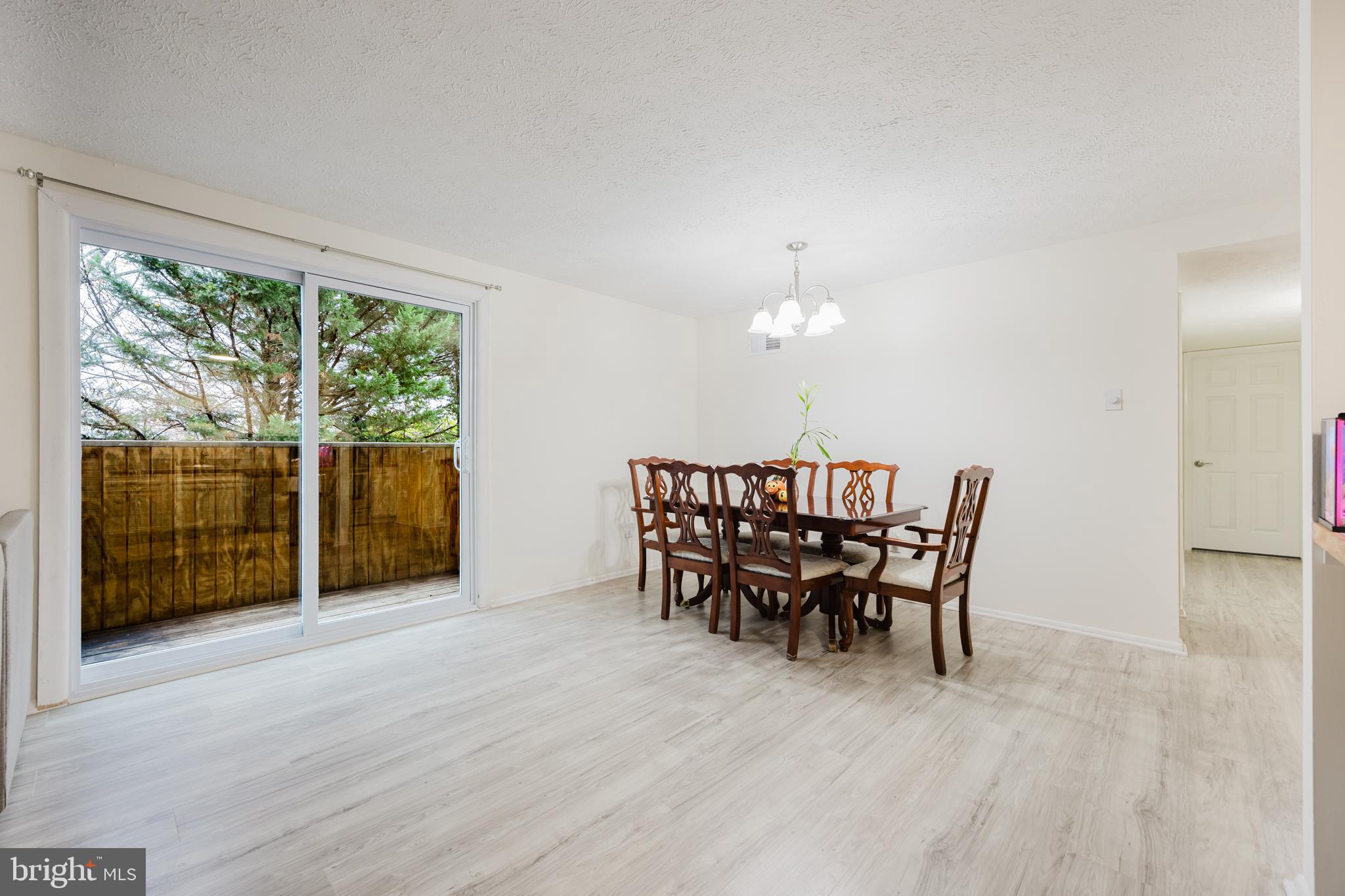 19621 Gunners Branch Road, Unit 823 Germantown, MD 20876 - Photo 20 of 49 a dining room with furniture a chandelier and wooden floor