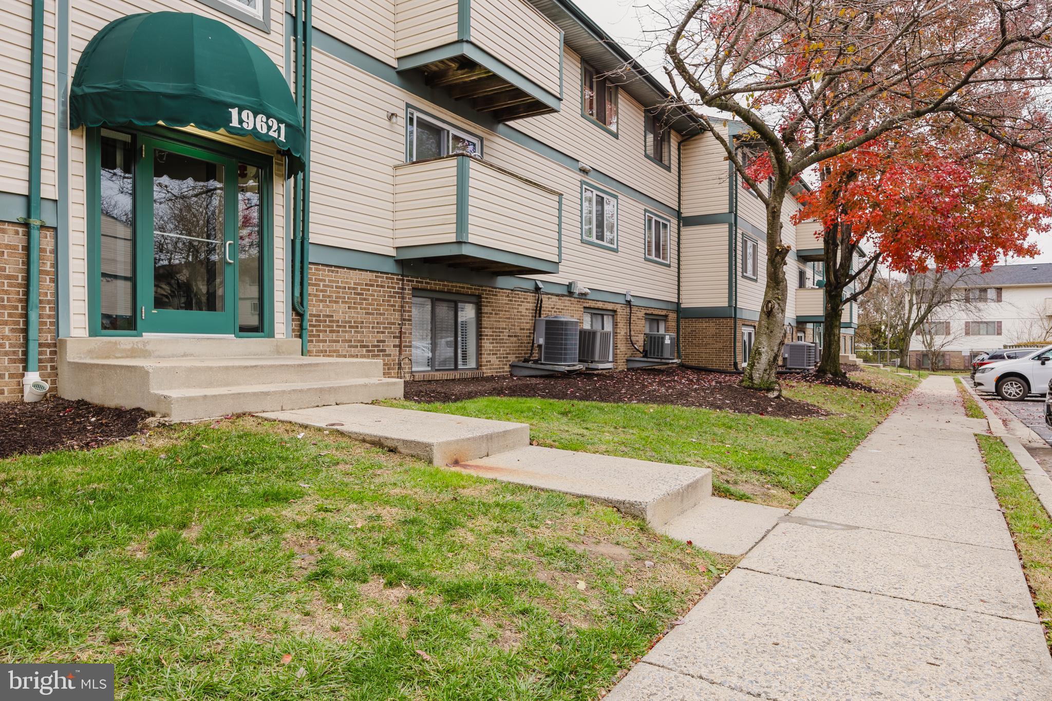 19621 Gunners Branch Road, Unit 823 Germantown, MD 20876 - Photo 2 of 49 a view of a white house with a yard and plants