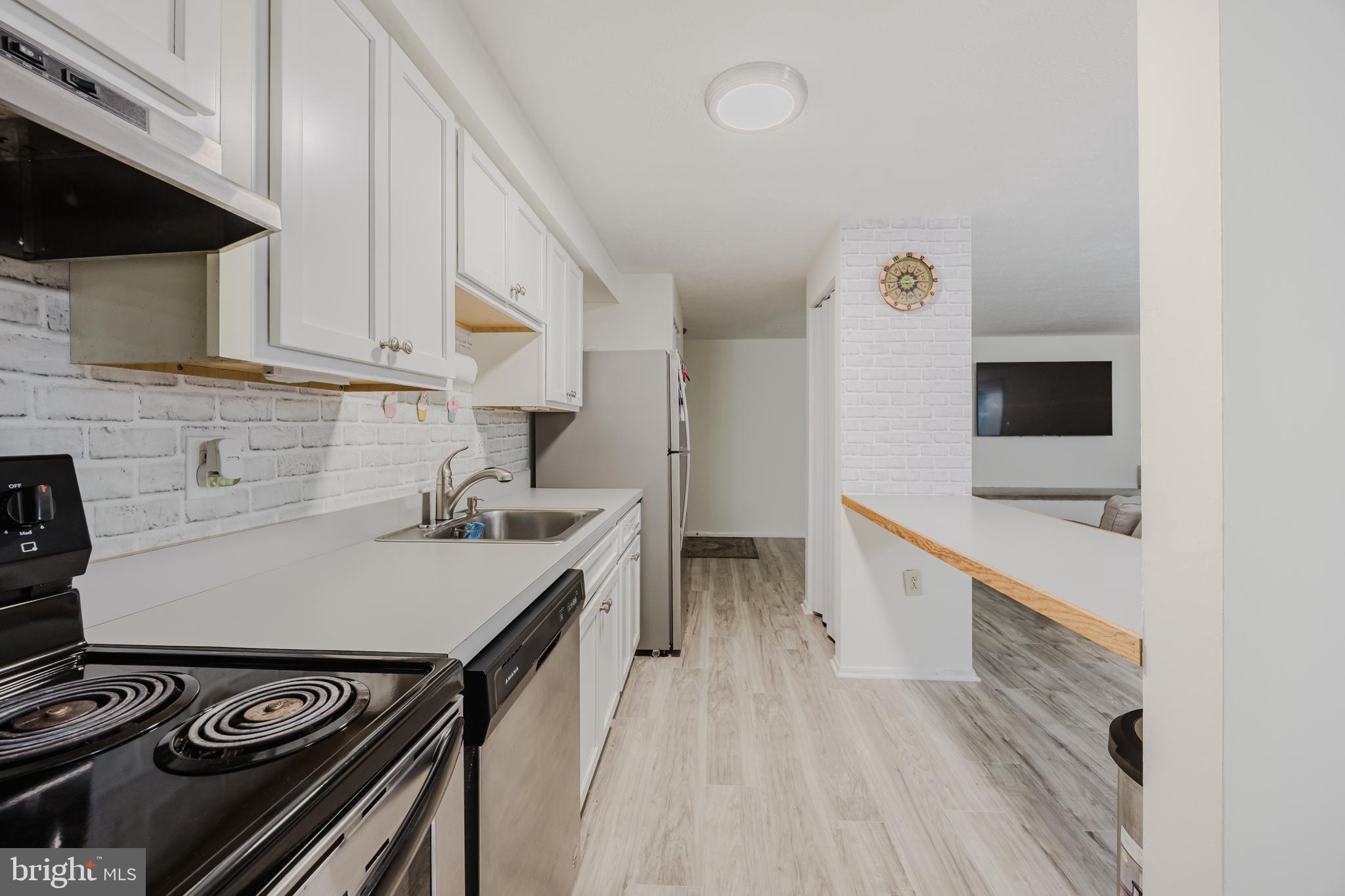 19621 Gunners Branch Road, Unit 823 Germantown, MD 20876 - Photo 24 of 49 a kitchen with a stove and a sink
