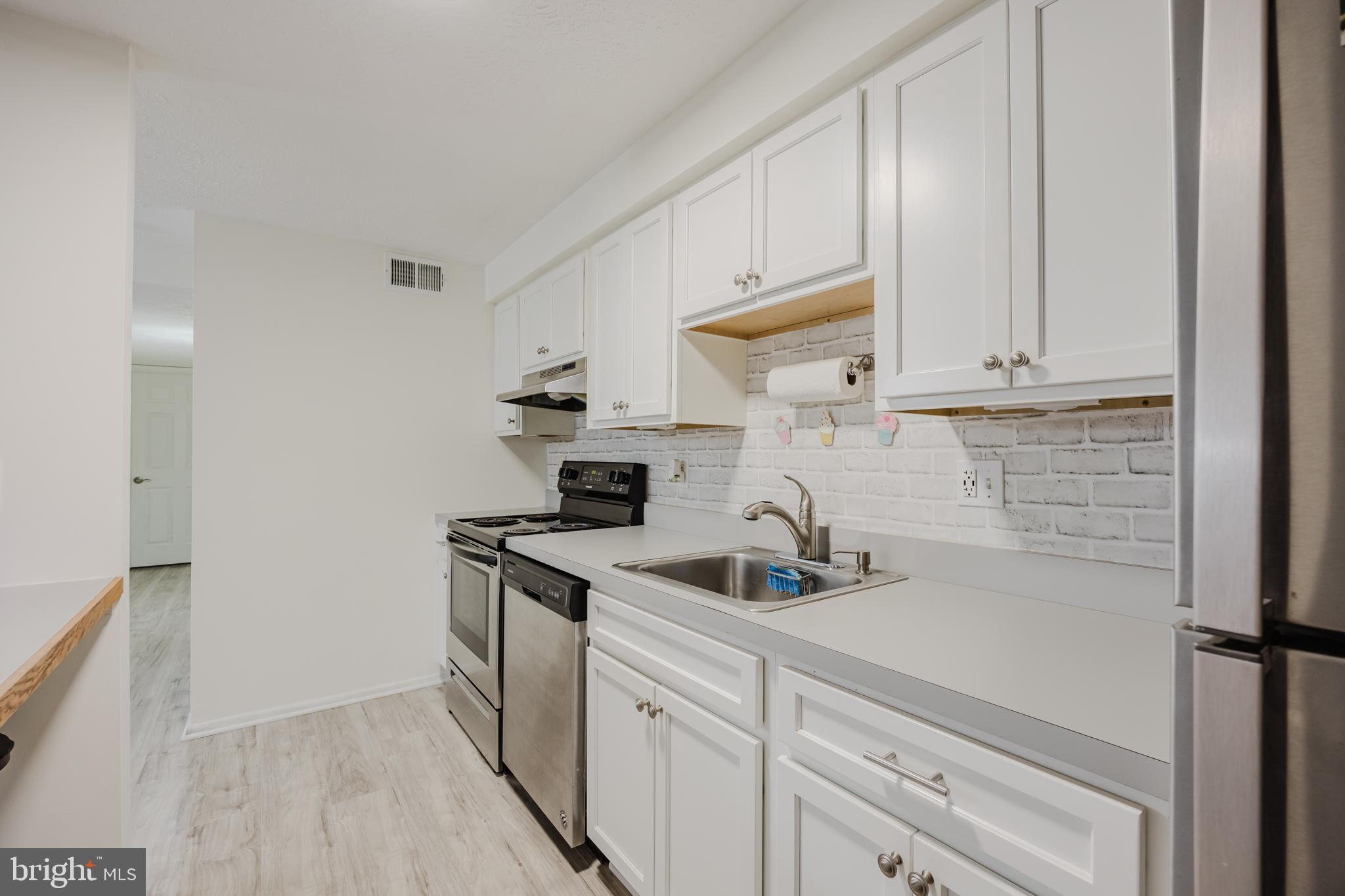 19621 Gunners Branch Road, Unit 823 Germantown, MD 20876 - Photo 26 of 49 a kitchen with a sink and cabinets