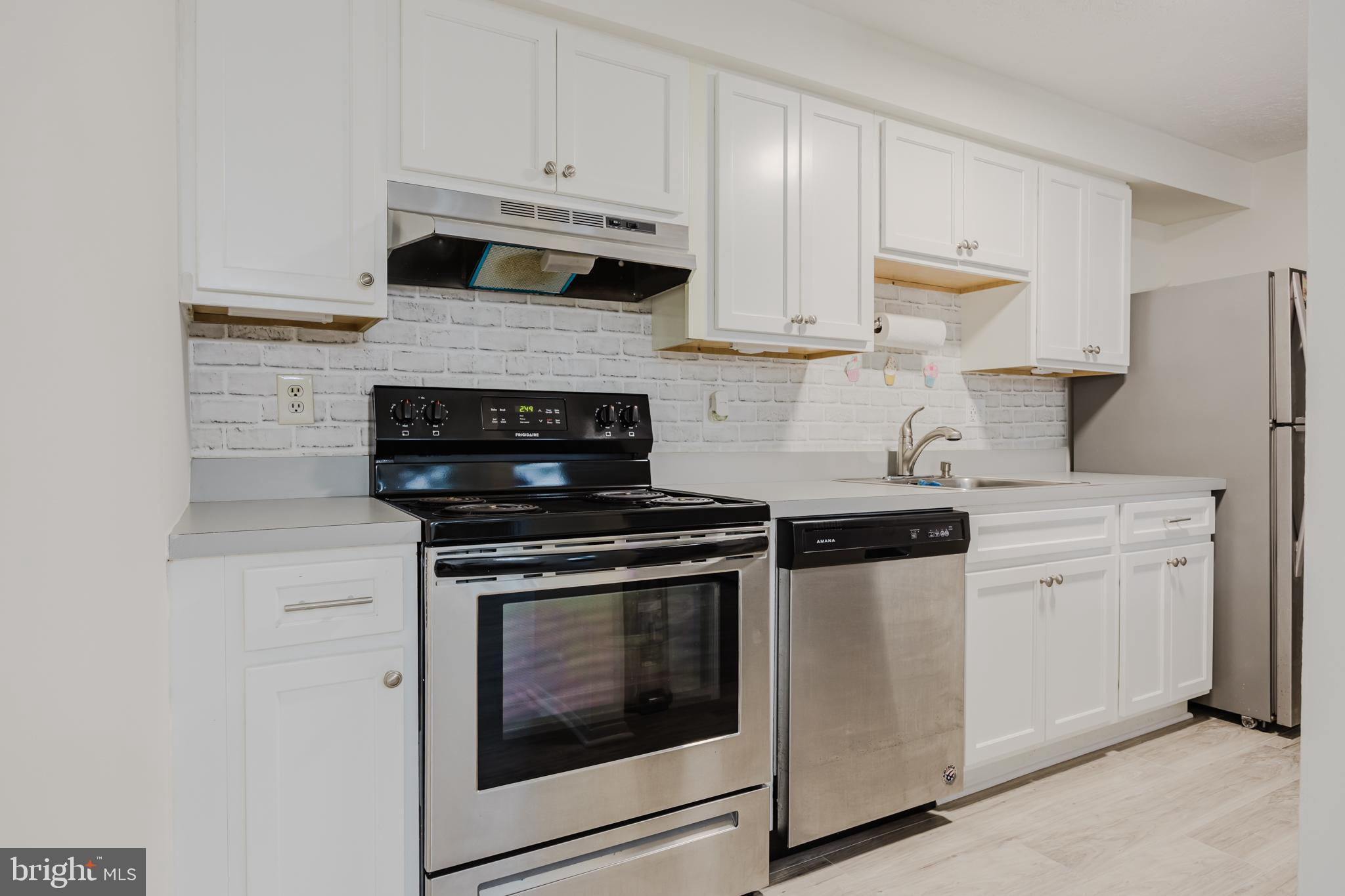 19621 Gunners Branch Road, Unit 823 Germantown, MD 20876 - Photo 28 of 49 a kitchen with cabinets stainless steel appliances and a counter space