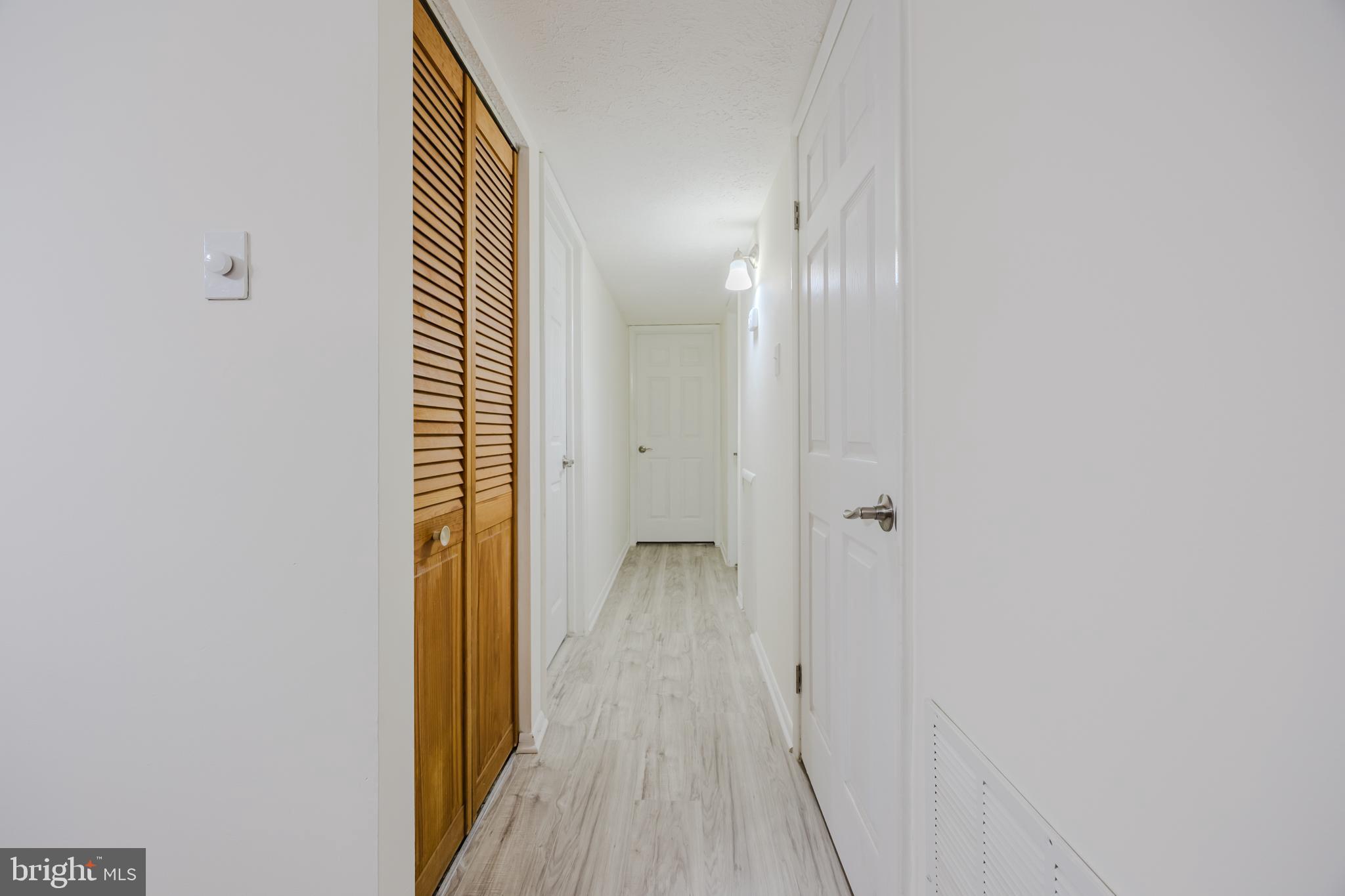 19621 Gunners Branch Road, Unit 823 Germantown, MD 20876 - Photo 32 of 49 a view of a hallway with wooden floor