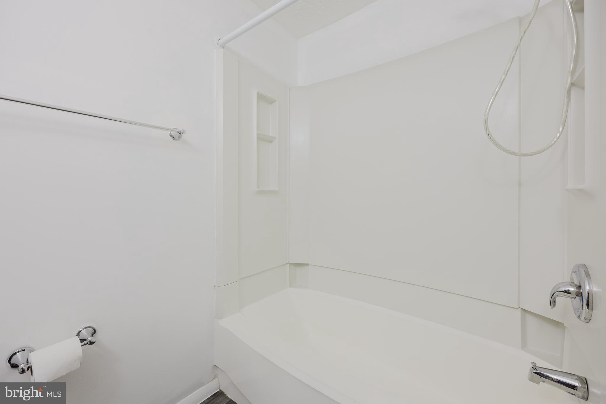 19621 Gunners Branch Road, Unit 823 Germantown, MD 20876 - Photo 37 of 49 a bathroom with a white bath tub and a shower