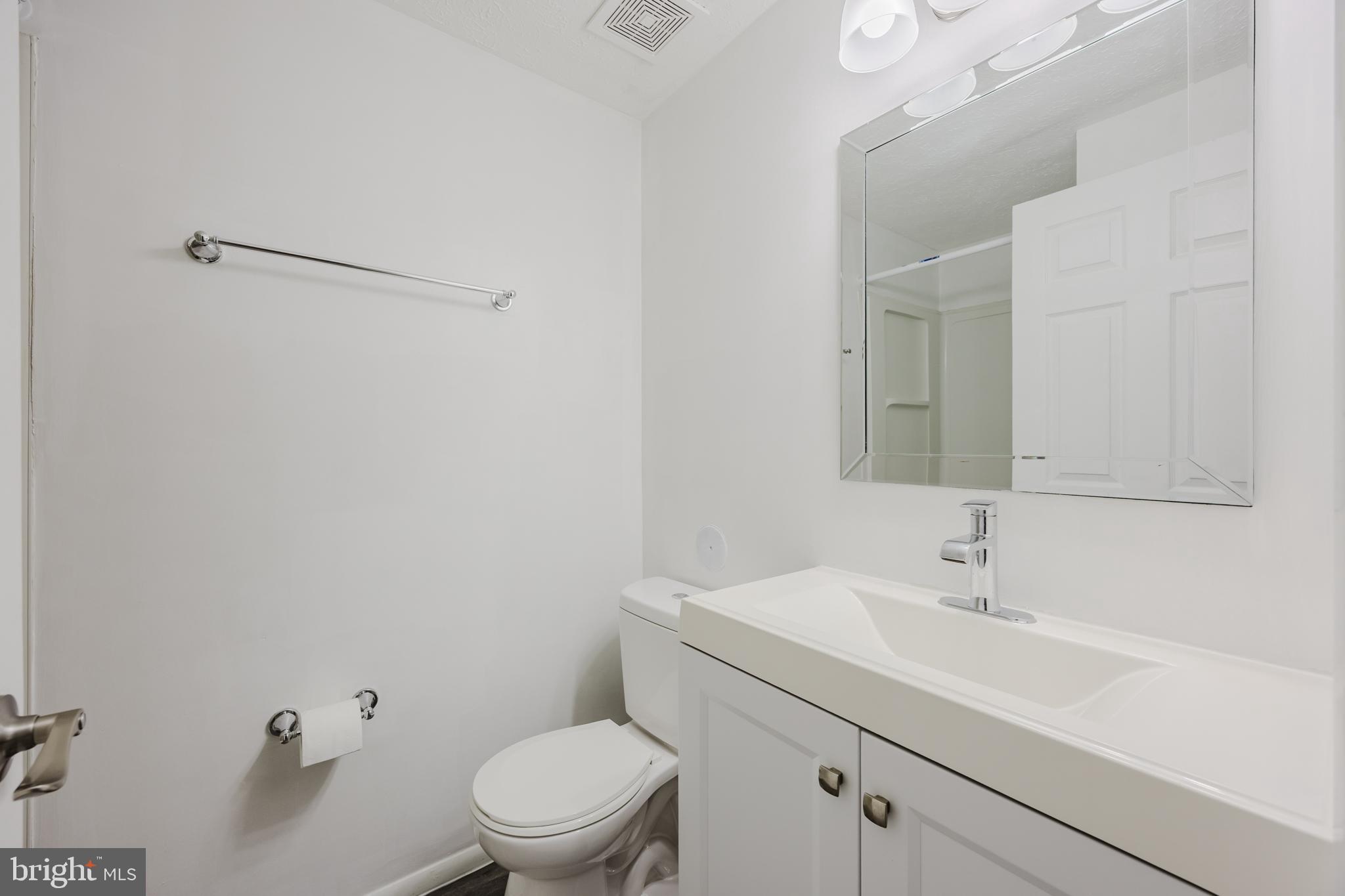 19621 Gunners Branch Road, Unit 823 Germantown, MD 20876 - Photo 38 of 49 a bathroom with a sink a toilet and a mirror