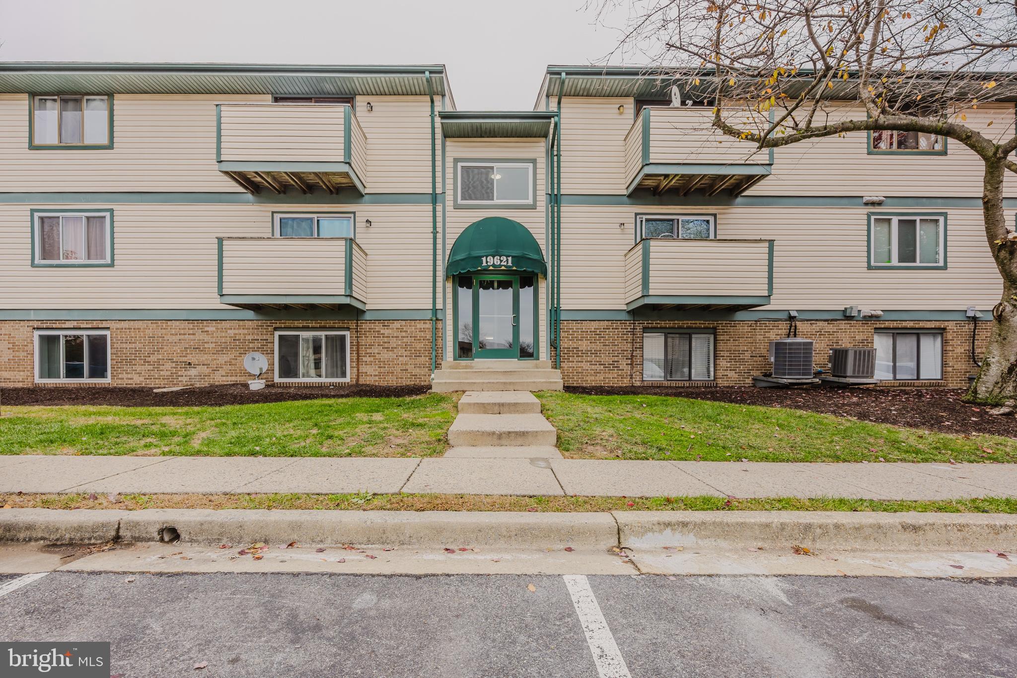 19621 Gunners Branch Road, Unit 823 Germantown, MD 20876 - Photo 7 of 49 a front view of a house with a garden and parking