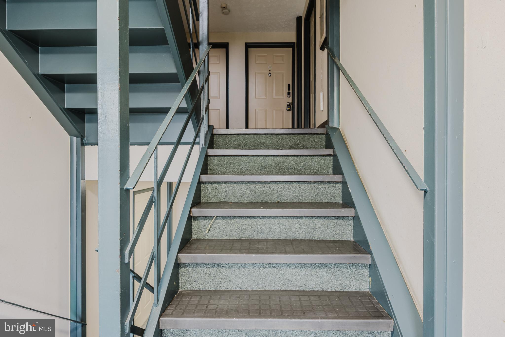 19621 Gunners Branch Road, Unit 823 Germantown, MD 20876 - Photo 9 of 49 a view of staircase with lots of frames on wall
