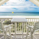 a view of a balcony with wooden floor and fence