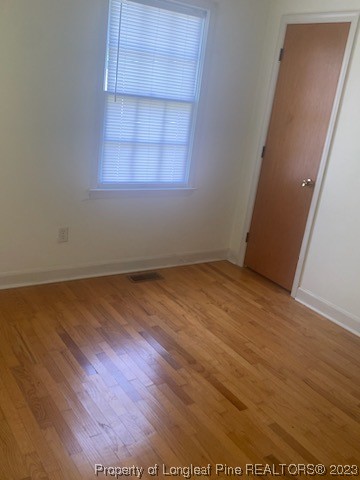 14 Richardson Road Bladenboro, NC 28320 - Photo 3 of 9 an empty room with wooden floor and windows