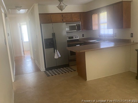 14 Richardson Road Bladenboro, NC 28320 - Photo 7 of 9 a kitchen with stainless steel appliances a refrigerator and a stove top oven