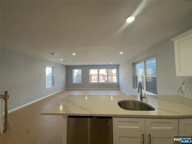 an empty room with wooden floor and a window