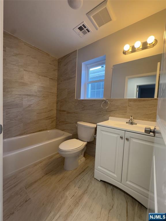 29 Isabella Avenue, Unit 2 Newark, NJ 07106 - Photo 14 of 35 a bathroom with a sink a toilet and bathtub