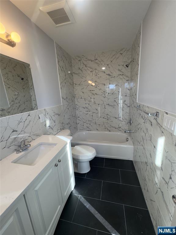 29 Isabella Avenue, Unit 2 Newark, NJ 07106 - Photo 31 of 35 a bathroom with a double vanity sink toilet and shower