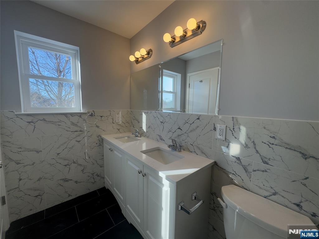 29 Isabella Avenue, Unit 2 Newark, NJ 07106 - Photo 32 of 35 a bathroom with a sink and a mirror