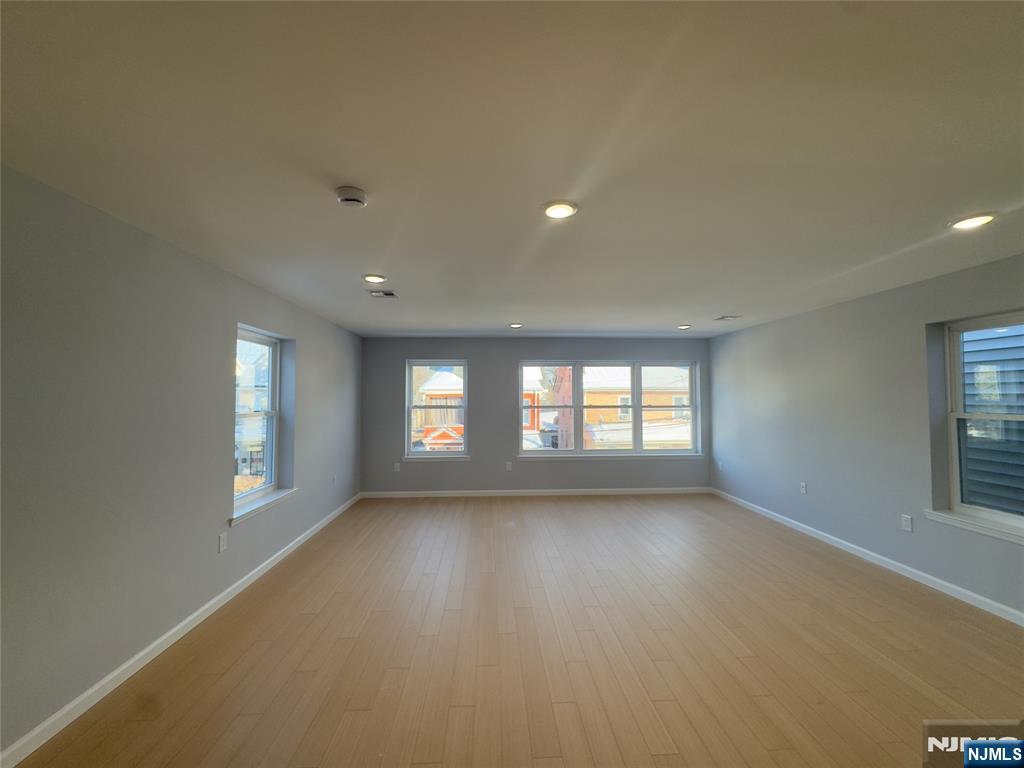 29 Isabella Avenue, Unit 2 Newark, NJ 07106 - Photo 10 of 35 wooden floor in an empty room with a window